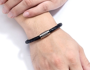 Close-up of a three-color braided leather bracelet on wrist with magnetic steel clasp