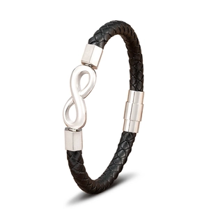 Detail of black braided leather bracelet with infinity symbol and magnetic metal clasp