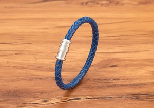 Blue braided leather bracelet detail with cylindrical silver magnetic metal clasp