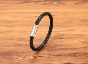 Detail shot of braided black leather bracelet with silver matte magnetic steel clasp