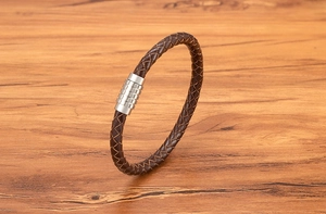 Macro shot of 6mm woven brown leather texture and textured silver magnetic metal clasp