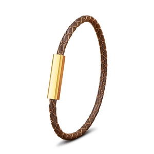 Brown braided leather bracelet with a polished gold magnetic clasp in a minimalist style