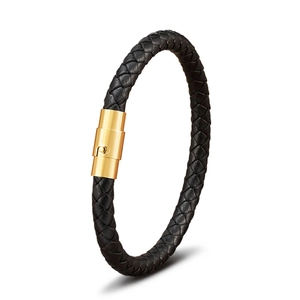 Macro detail of braided black leather bracelet with a polished gold stainless steel clasp