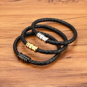 Three-piece set of woven black leather bracelets with magnetic clasps in gold silver and black