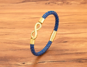 Close-up of infinity symbol and magnetic clasp on dark blue braided leather bracelet