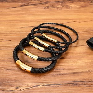 Five-piece set of woven black leather bracelets with polished gold stainless steel clasps