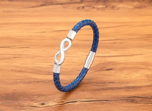 Close-up of blue braided leather bracelet with silver infinity symbol and magnetic clasp