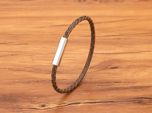 Detailed view of brown braided leather cord and polished silver magnetic clasp for men