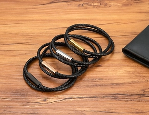 Close-up of black braided leather bracelets with colorful magnetic metal clasps