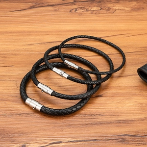 Set of four black braided leather bracelets with minimalist stainless steel clasps