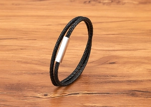 Close-up of double-wrap black woven leather bracelet with silver magnetic steel clasp