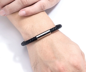 Détails de la texture en cuir noir tressé et fermoir magnétique en acier argenté pour homme