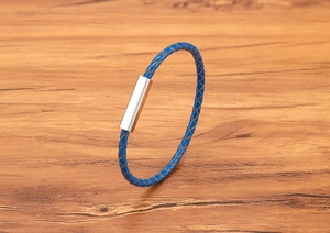 Detailed close-up of blue braided leather strap and polished magnetic steel clasp