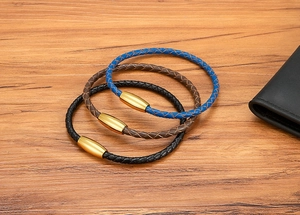 Detailed view of blue and brown 4mm braided leather bracelets with gold magnetic clasps