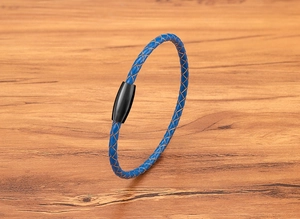 Detail view of blue braided leather bracelet with black magnetic stainless steel clasp