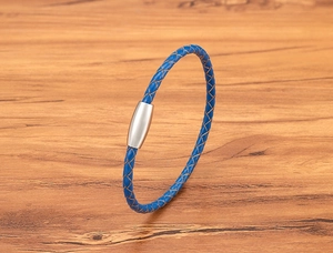 Close-up of blue braided leather bracelet with silver magnetic stainless steel clasp