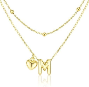 Detail of gold double-layered necklace with 3D heart and letter M pendants