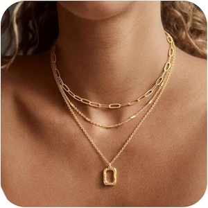 Three-layer gold necklace set featuring paperclip chain and rectangle pendant on neck