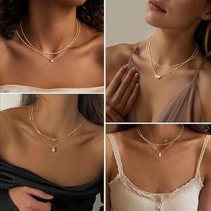 Double-layered gold titanium steel necklace with small diamond and gold bead pendant
