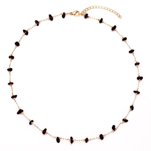 Gold chain necklace featuring irregular raw red agate stones and lobster clasp closure