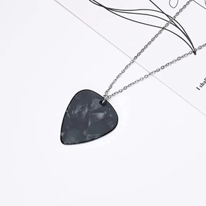 Macro shot of black marble texture guitar pick pendant with slim silver metal chain