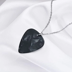 Black marble guitar pick necklace with silver chain on white silk background