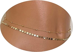 Detailed view of a layered gold chain featuring delicate beads and circular sequins