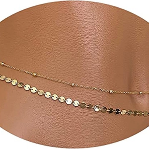 Double-layered golden waist chain with sequins and beads on skin