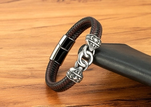 Macro detail of braided leather bracelet with vintage silver link and magnetic buckle