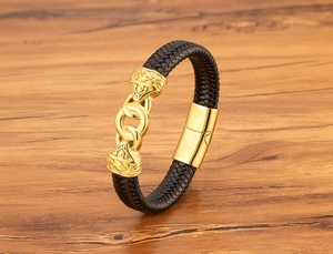 Macro detail of men's braided leather bracelet with golden engraved magnetic clasp