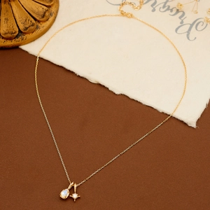 Elegant gold necklace set with natural moonstone and star pendant on vintage background