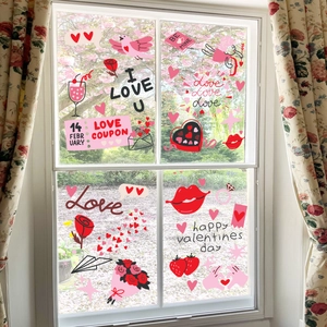 Detail van Valentijnsdag raamstickers met hart- en vogelmotieven op een glazen raam