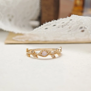 Macro detail of S925 sterling silver vine ring featuring a round opal stone center