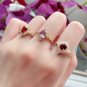Detailed close-up of retro 925 silver gold-plated rings with garnets and zircons