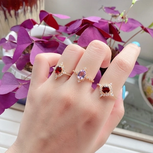 Vintage 925 silver gold-plated rings set with garnets and purple zircon on woman hand