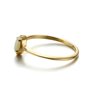 Detailed macro view of 18k gold plated s925 silver ring featuring an oval white opal stone