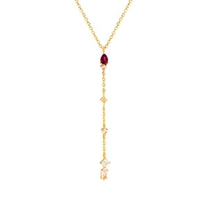 Dettaglio di una collana Y-lariat dorata con rubino a pera e ciondolo a stella