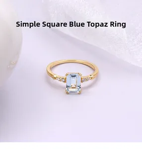 Detail eines blauen Topas-Rings im Smaragdschliff mit Diamanten und Vintage-Perlenrand