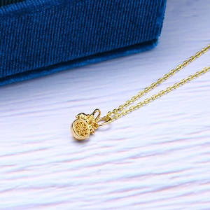 Detailed view of a golden lucky bag pendant on a fine S925 sterling silver chain