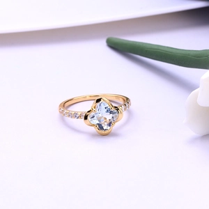Macro shot of 925 sterling silver stamp on golden four-leaf clover ring with diamonds