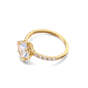 Detailed macro view of the floral setting with a brilliant round cut gemstone on a gold ring