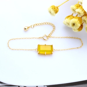 Detailed view of 925 sterling silver gold bracelet with rectangular yellow chalcedony