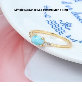 Close-up of a natural Larimar ring with blue stone and sparkling zircon side accents