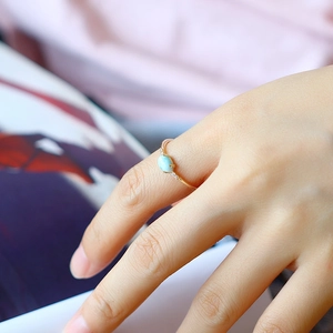 Elegant gold minimalist ring with oval blue Larimar stone and small side zircon accents