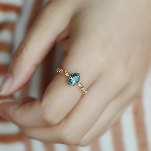 Macro di anello vintage in oro con topazio blu Londra e accenti laterali in zircone