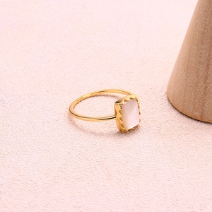 Détail d'une bague en argent S925 doré avec nacre rectangulaire et bordure festonnée