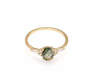 Macro shot of S925 engraved stamp and oval green rutilated quartz on gold plated ring