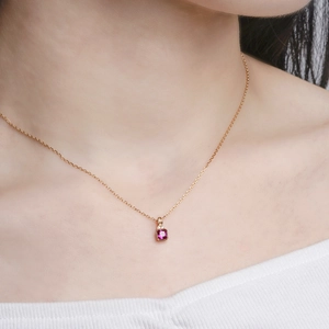 Elegant gold-plated S925 silver necklace with square magenta corundum stone on a model