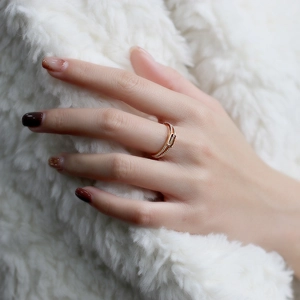 Detail of s925 gold-plated ring with brown gemstone and double row of pavé diamonds