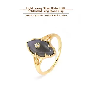 Macro shot of oval labradorite ring with a white zircon star on 14K gold plated silver